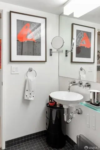 a bathroom with a toilet a sink and a mirror
