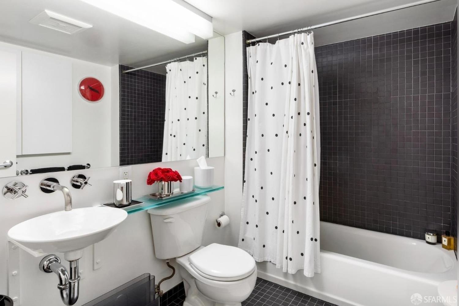 855 Folsom Street, Unit 519 San Francisco, CA 94107 - Photo 19 of 25 a bathroom with a sink a toilet and shower curtain