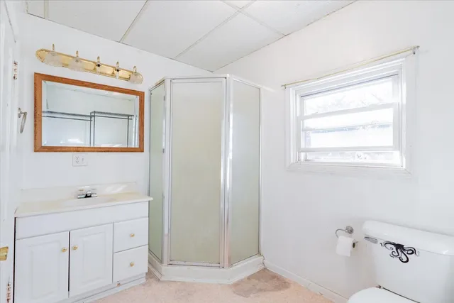 a bathroom with a sink mirror and vanity