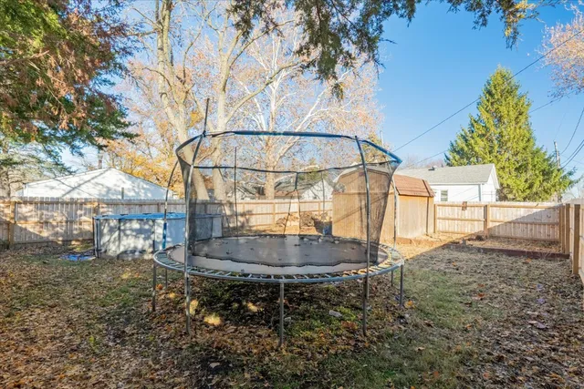 a backyard of a house with table and chairs