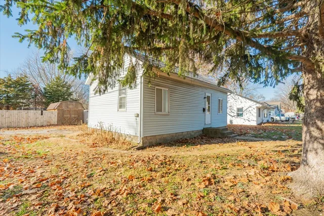 a view of a house with a yard covered with snow