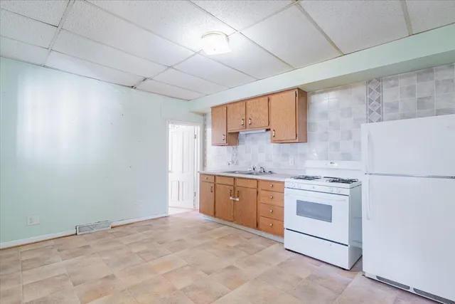 a kitchen with granite countertop white cabinets stainless steel appliances and sink