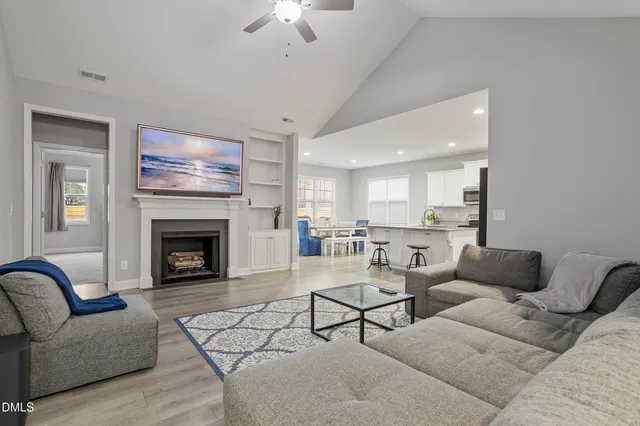 a living room with furniture and a fireplace
