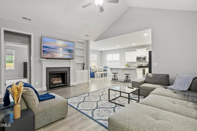 a living room with furniture and a fireplace