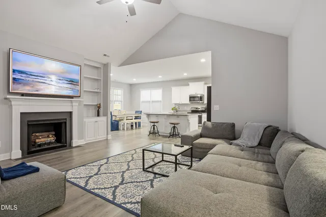 a living room with furniture and a view of kitchen