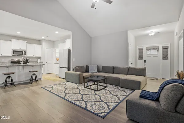 a living room with furniture and a chandelier