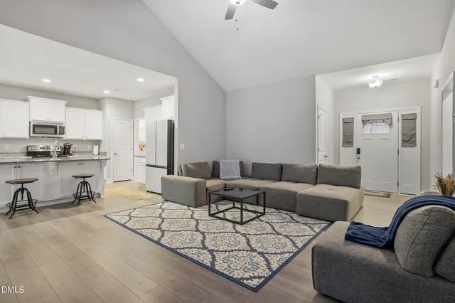 a living room with furniture and a chandelier