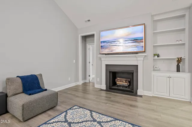 a kitchen with stainless steel appliances granite countertop a sink a stove a refrigerator cabinets and chairs