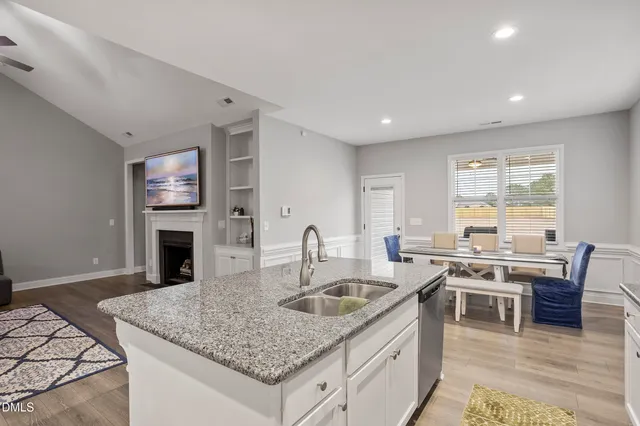 a kitchen with stainless steel appliances granite countertop white cabinets sink and stove