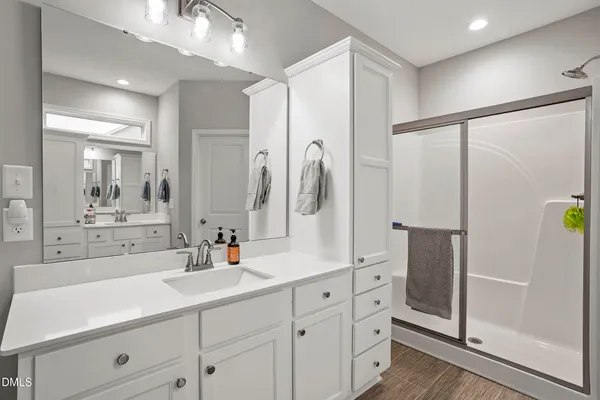 a bathroom with a double vanity sink mirror and