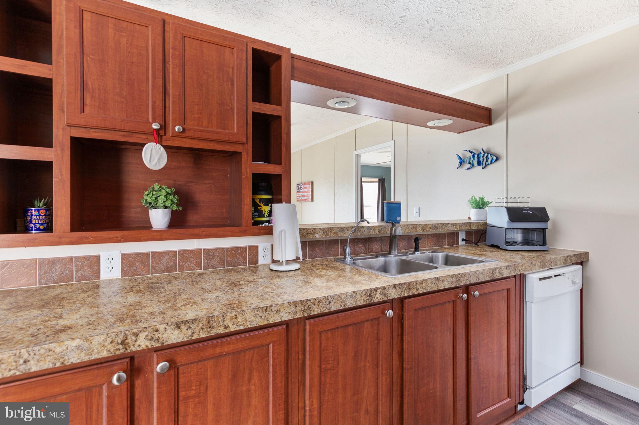 2300 Osborne Road Chester, VA 23831 - Photo 12 of 26 a kitchen with stainless steel appliances granite countertop a sink and a wooden cabinets