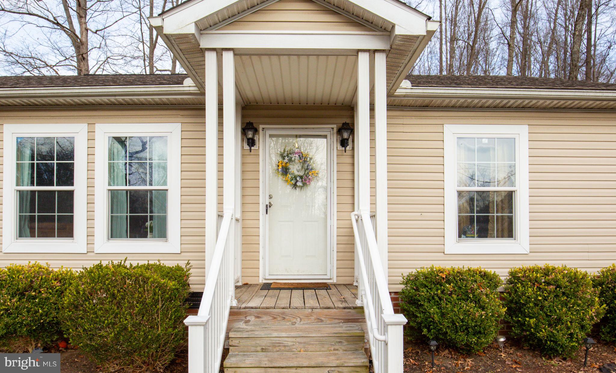 2300 Osborne Road Chester, VA 23831 - Photo 4 of 26 a front view of a house with a yard