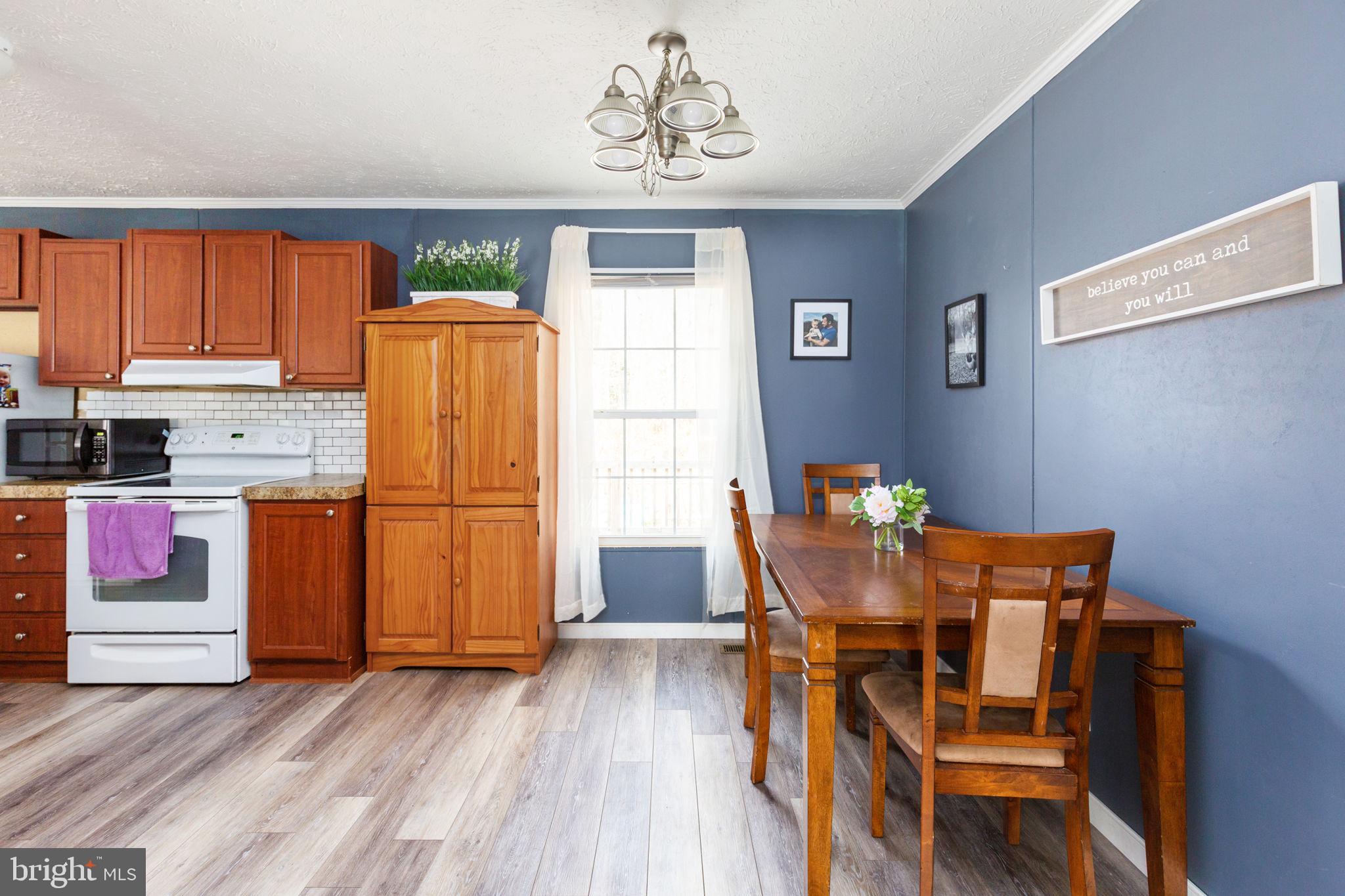 2300 Osborne Road Chester, VA 23831 - Photo 9 of 26 a dining room with furniture and wooden floor