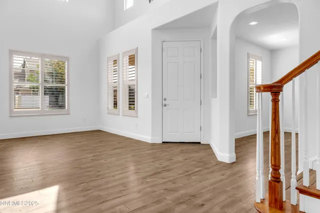 a view of an empty room with a kitchen