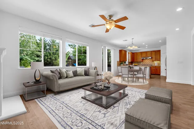 a kitchen with stainless steel appliances granite countertop a stove a sink and a refrigerator with wooden floor