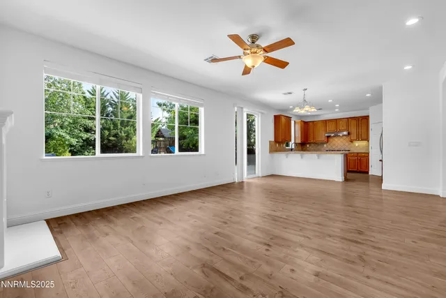a kitchen with granite countertop a sink a counter top space and cabinets