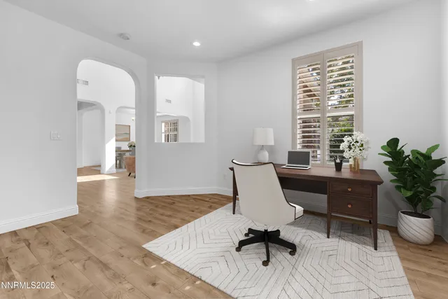 a view of a a dining room with furniture a chandelier and wooden floor