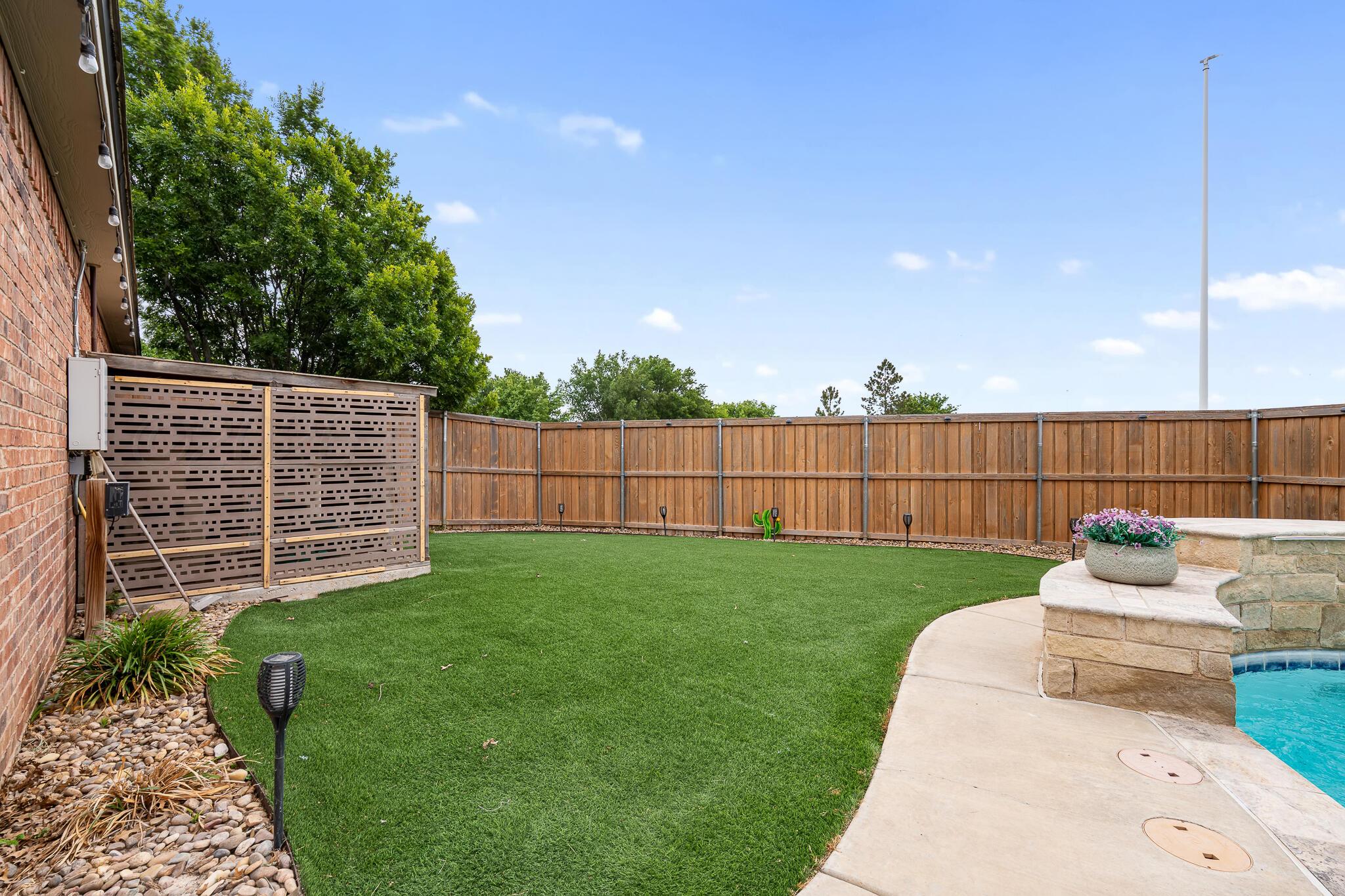 5008 Wesley Road Amarillo, TX 79119 - Photo 42 of 47 a garden view with a seating space