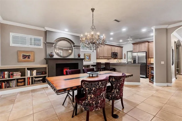 a dining room with furniture a kitchen and a chandelier