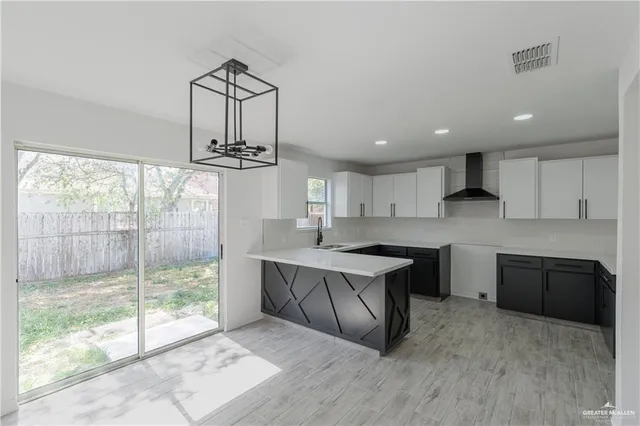 a kitchen with kitchen island a counter top space appliances and cabinets