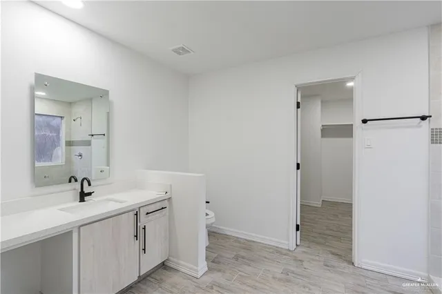 a bathroom with a double vanity sink and mirror