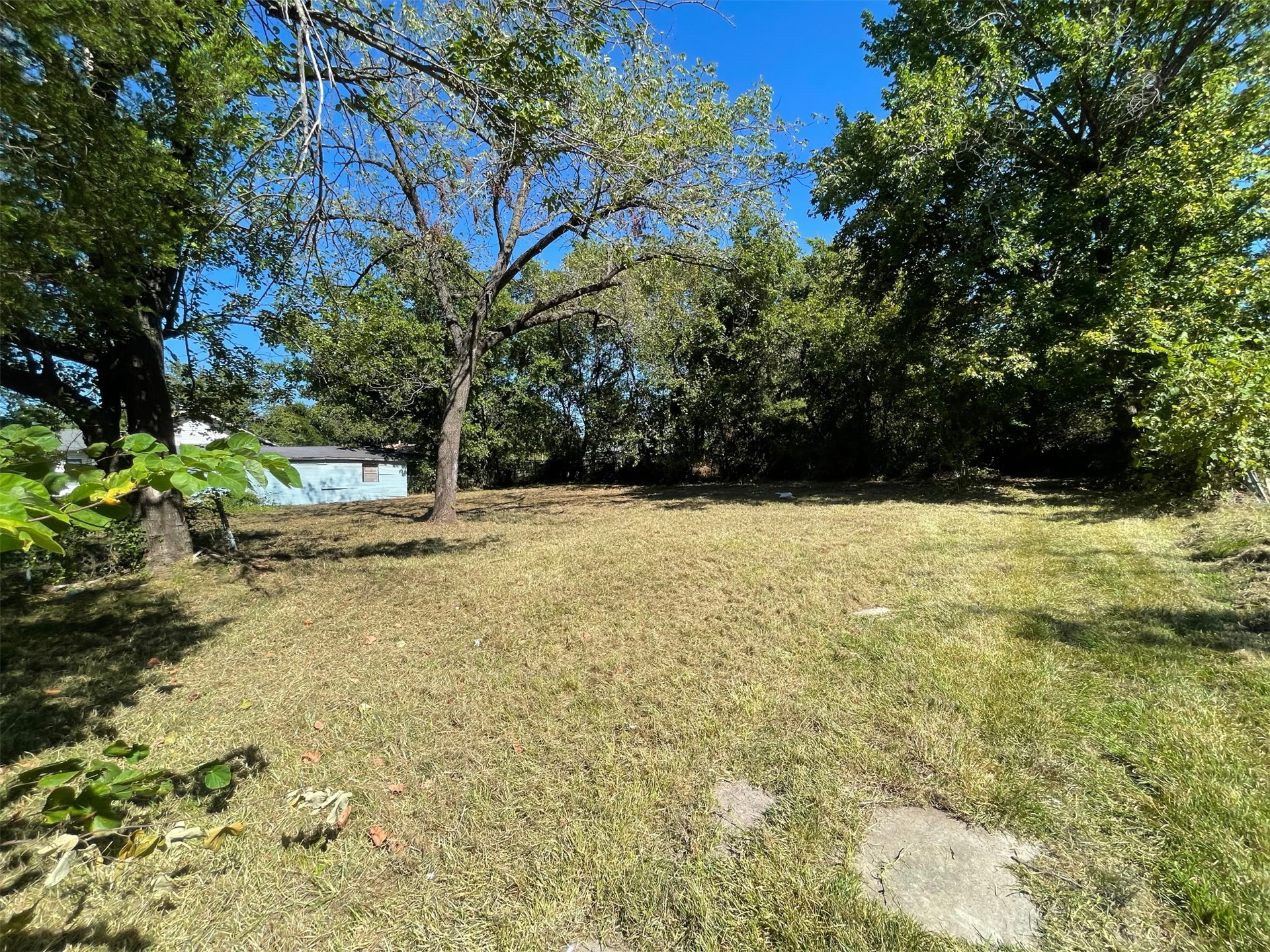 116 Geneva Street Muskogee, OK 74403 - Photo 1 of 3 Expansive open lot with mature trees and natural landscaping