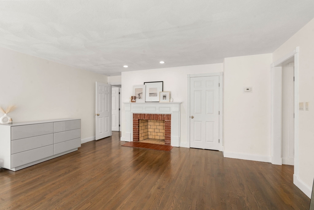23 Bubbling Brook Road Walpole, MA 02081 - Photo 20 of 41 a view of a room with wooden floor and fireplace