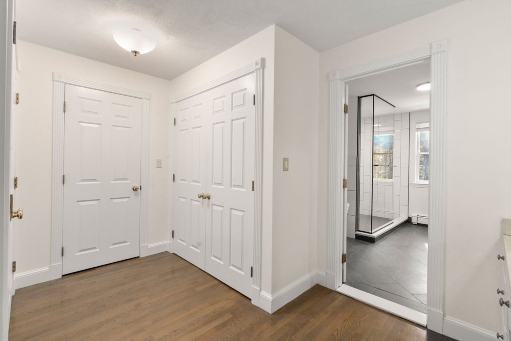 23 Bubbling Brook Road Walpole, MA 02081 - Photo 21 of 41 a view of a hallway with wooden floor