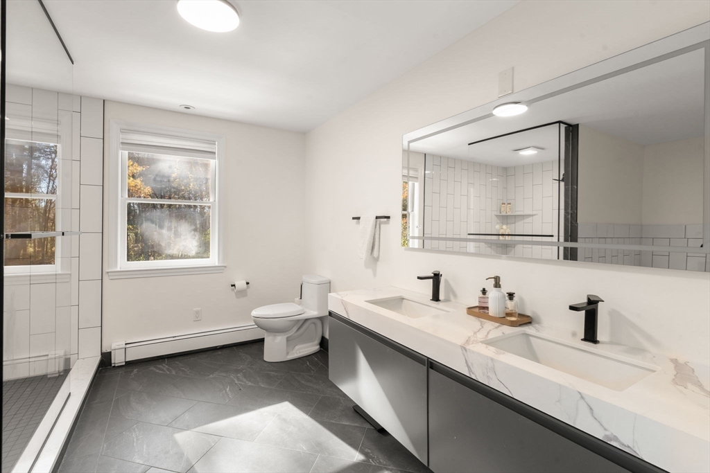 23 Bubbling Brook Road Walpole, MA 02081 - Photo 22 of 41 a bathroom with a double vanity sink toilet mirror and window