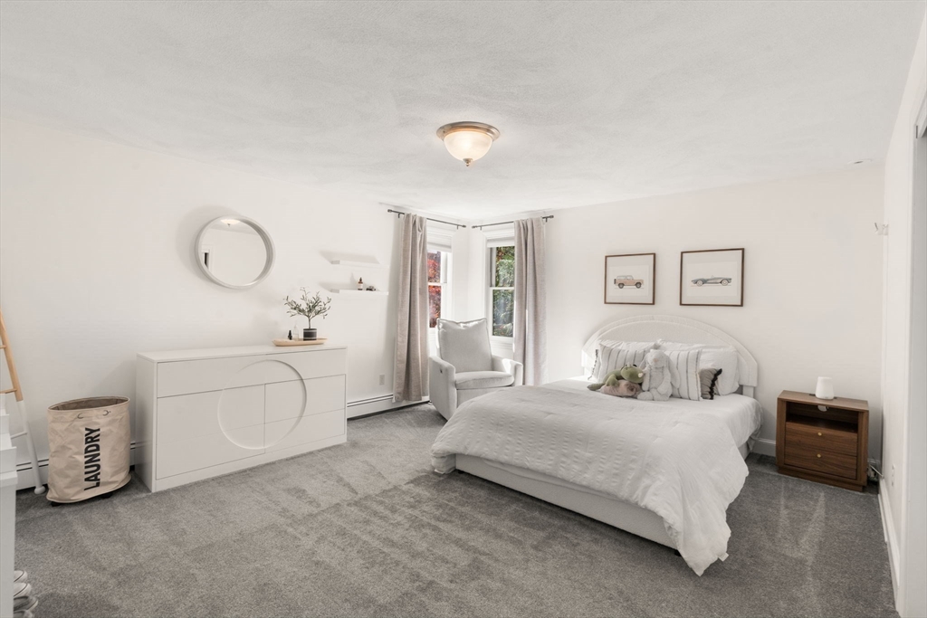 23 Bubbling Brook Road Walpole, MA 02081 - Photo 25 of 41 a bedroom with a bed and a lamp