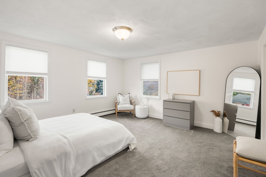 23 Bubbling Brook Road Walpole, MA 02081 - Photo 27 of 41 a spacious bedroom with a bed and a large window