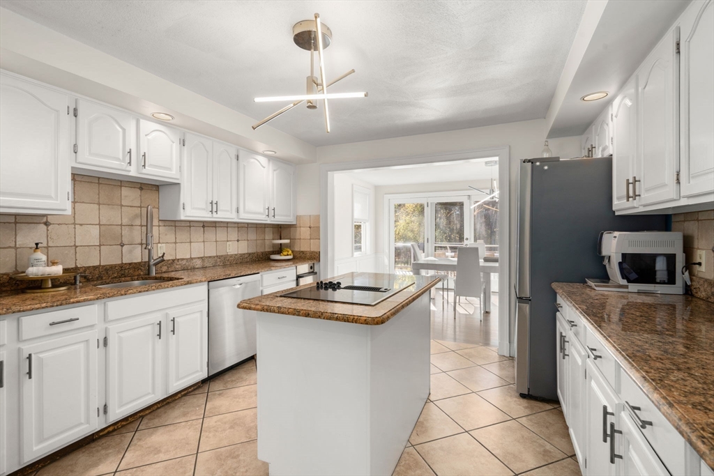 23 Bubbling Brook Road Walpole, MA 02081 - Photo 10 of 41 a kitchen with stainless steel appliances granite countertop a sink stove and refrigerator