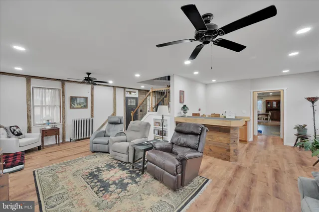a dining room with furniture a chandelier and window