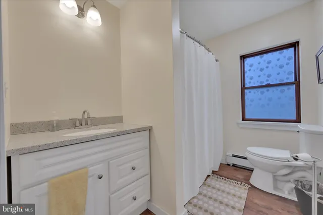 a view of a hallway with wooden walls