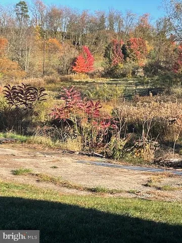 a view of a house with wooden fence and large windows