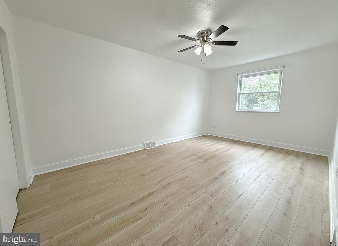 7332 Ruskin Road Philadelphia, PA 19151 - Photo 15 of 20 wooden floor in an empty room with a window