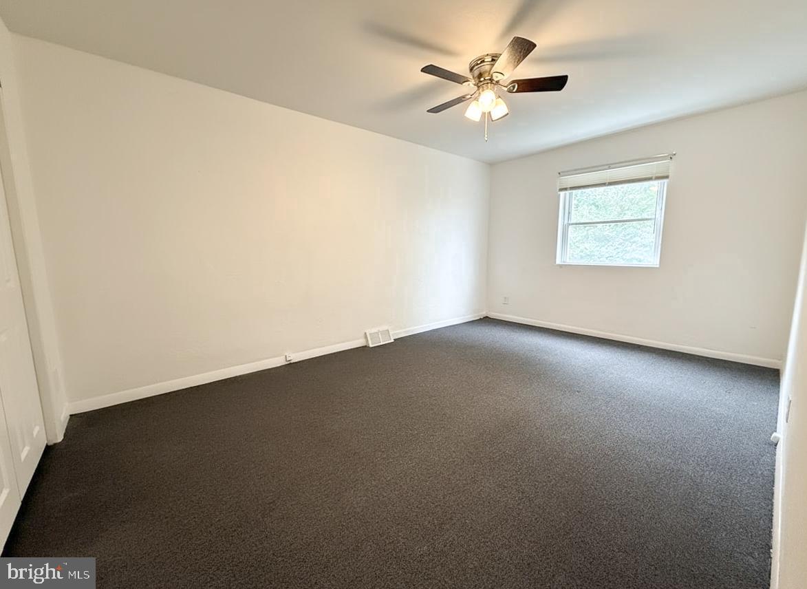 7332 Ruskin Road Philadelphia, PA 19151 - Photo 7 of 20 an empty room with a window and a ceiling fan