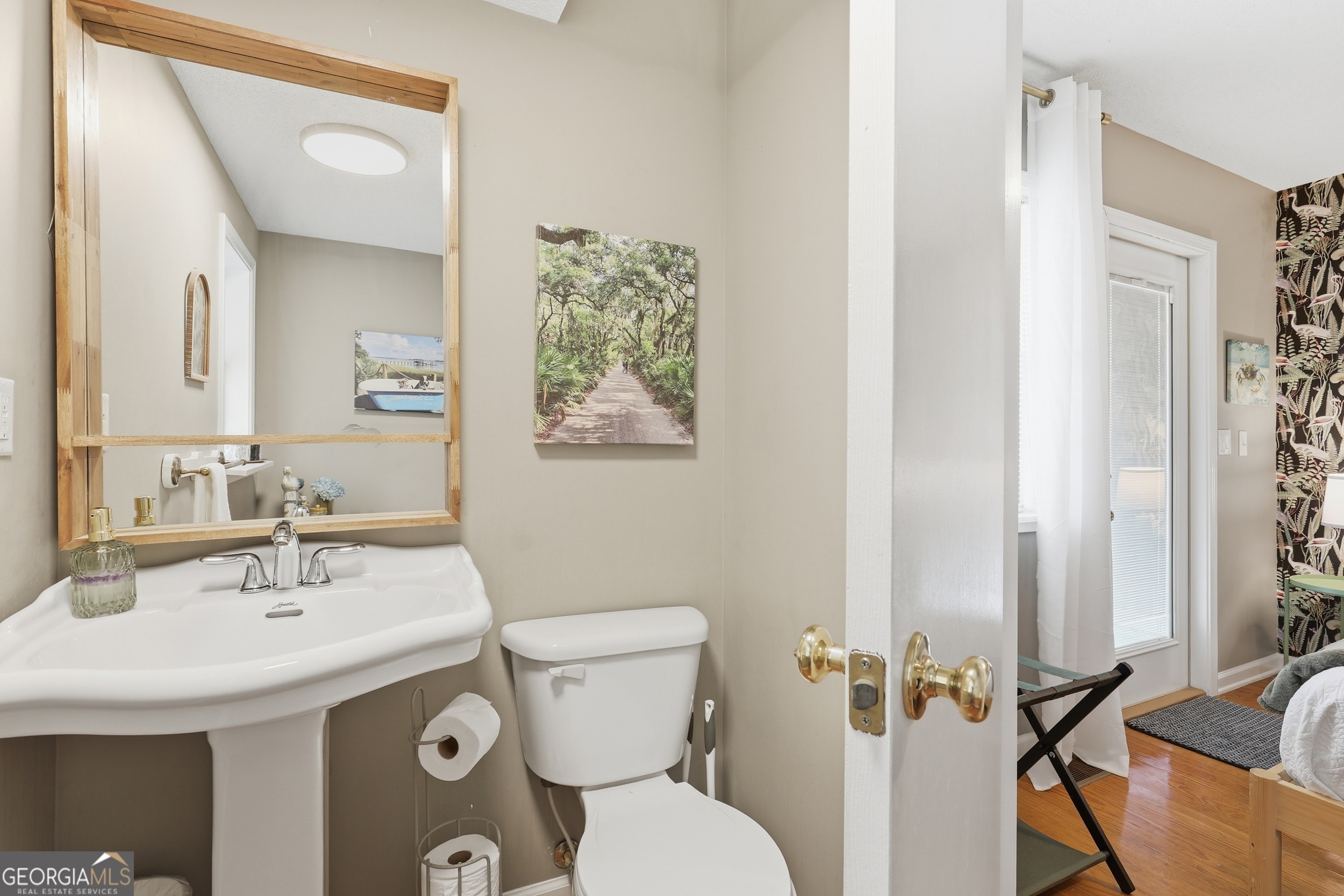 1629 South River Drive Townsend, GA 31331 - Photo 39 of 64 a bathroom with a sink and mirror with toilet