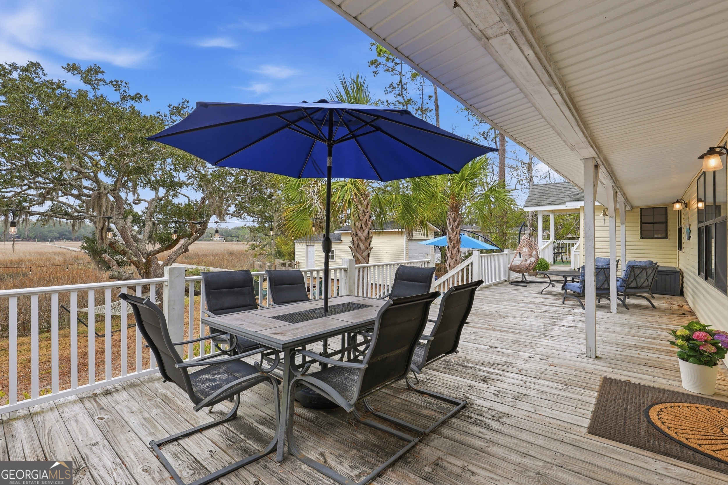 1629 South River Drive Townsend, GA 31331 - Photo 62 of 64 a view of a roof deck with table and chairs under an umbrella
