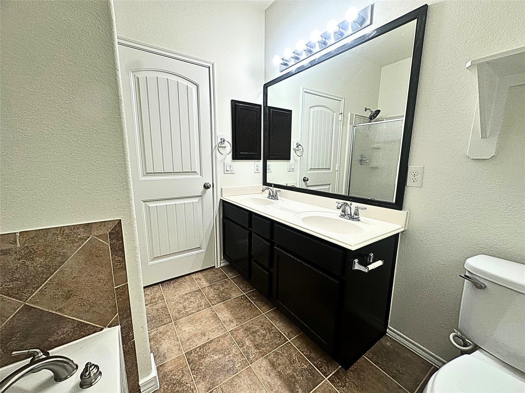 8218 Nagy Hill Street Spring, TX 77379 - Photo 16 of 30 a bathroom with a sink vanity granite toilet and a mirror