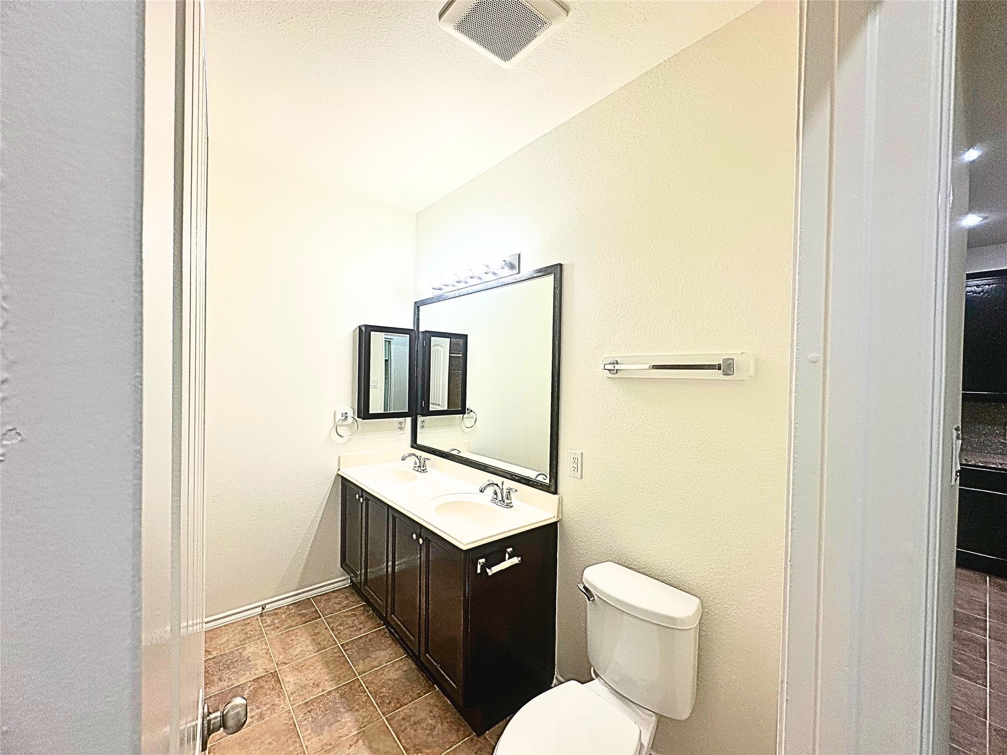 8218 Nagy Hill Street Spring, TX 77379 - Photo 24 of 30 a bathroom with a toilet a sink and mirror