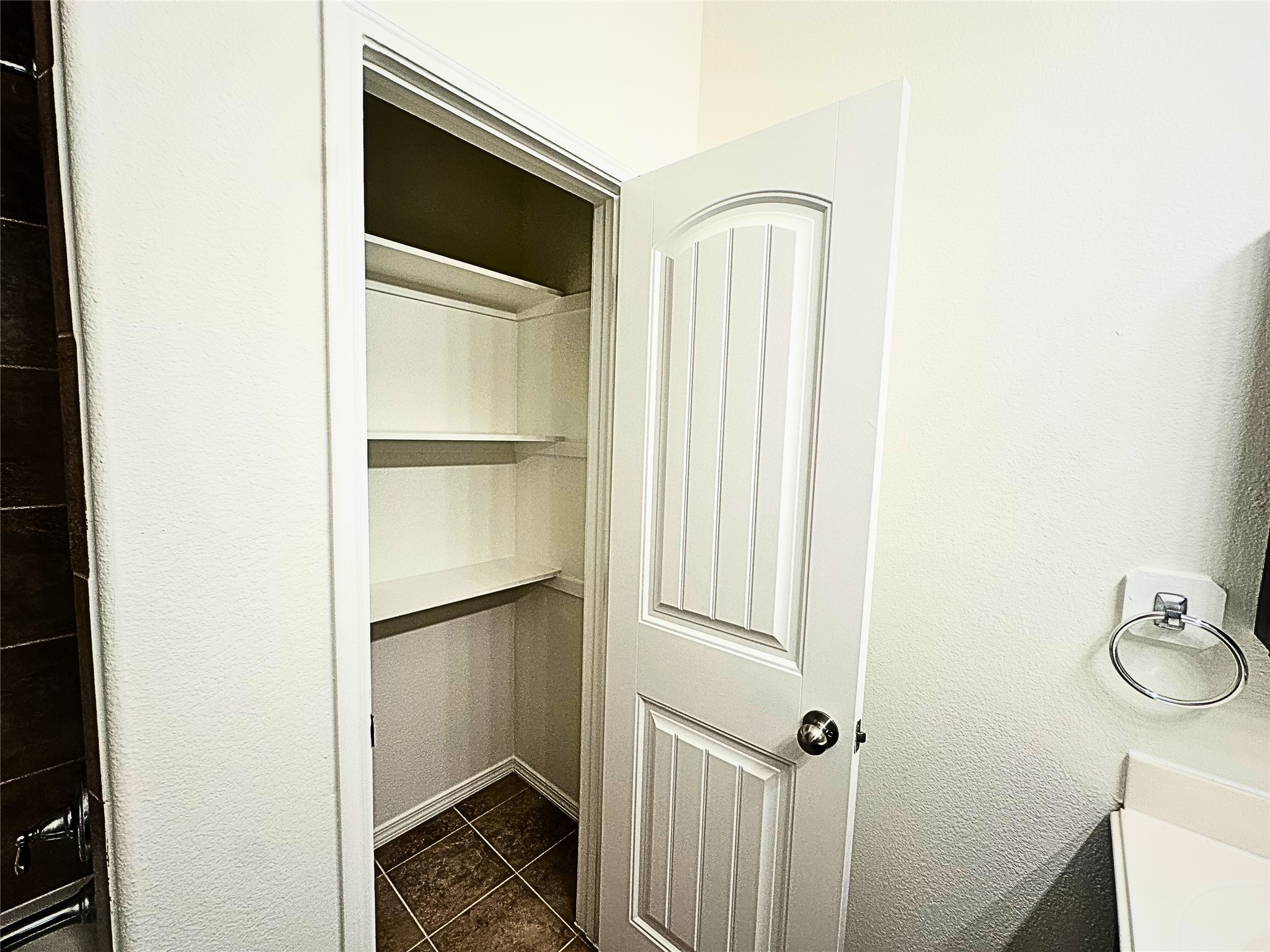 8218 Nagy Hill Street Spring, TX 77379 - Photo 26 of 30 a bathroom with a walk in closet and wooden floor