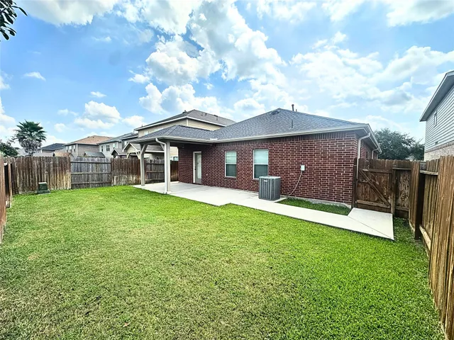 a view of a house with a yard and sitting area
