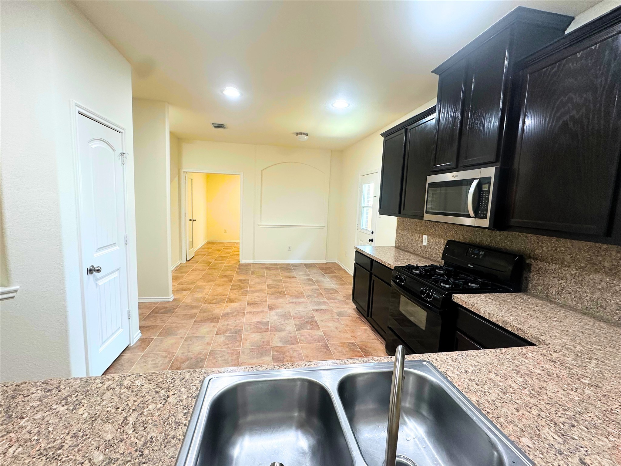 8218 Nagy Hill Street Spring, TX 77379 - Photo 4 of 30 a kitchen with granite countertop stove top oven and sink