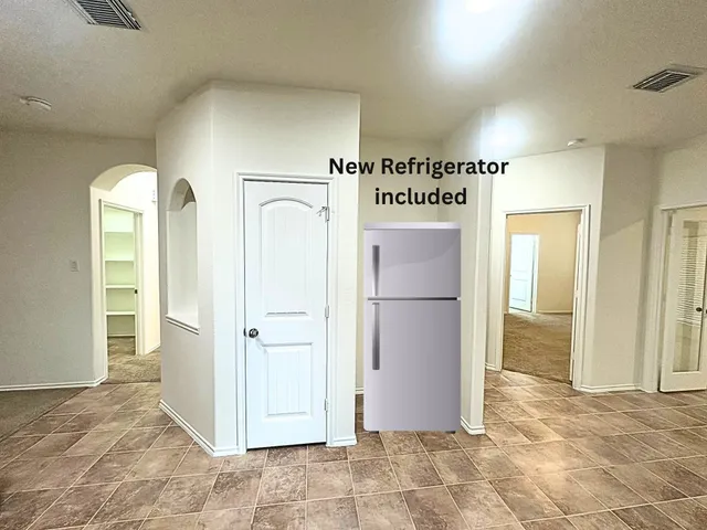 an empty room with closet and windows