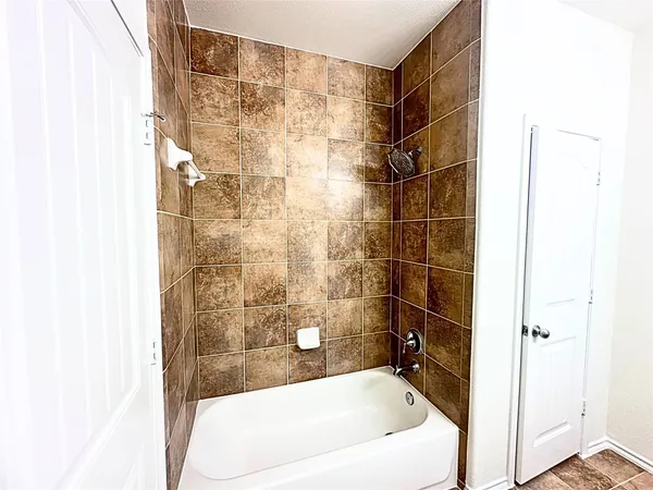 a bathroom with a bathtub and shower