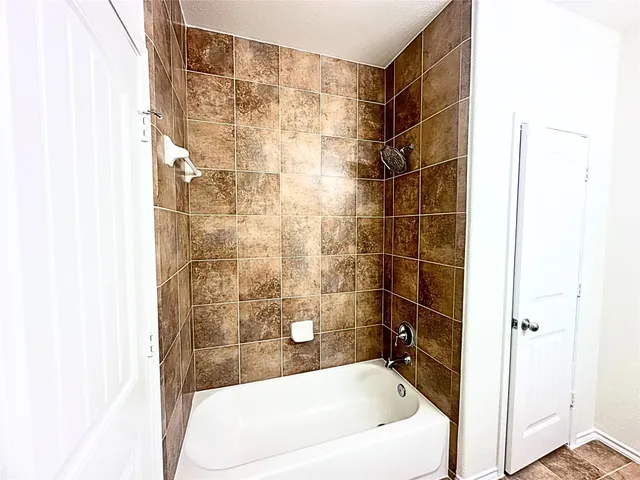 a bathroom with a bathtub and shower