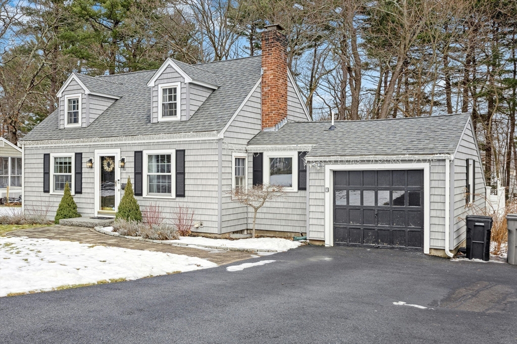 a front view of a house with a yard and a garage
