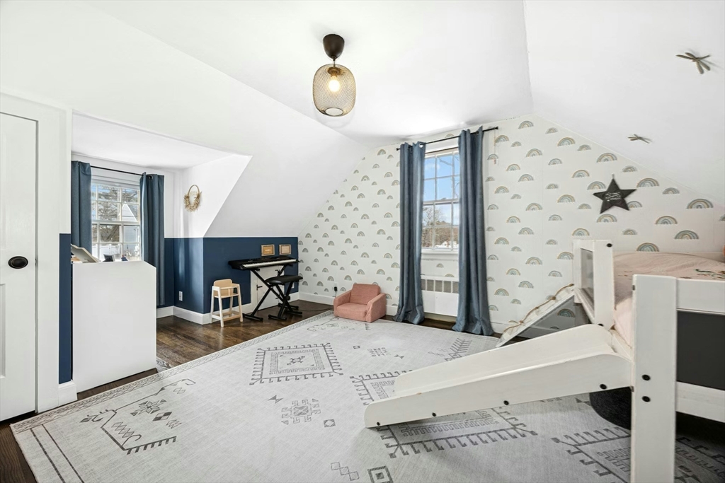 102 Spruce Street Framingham, MA 01701 - Photo 14 of 30 a bedroom with a bed and a flat tv screen on the dresser