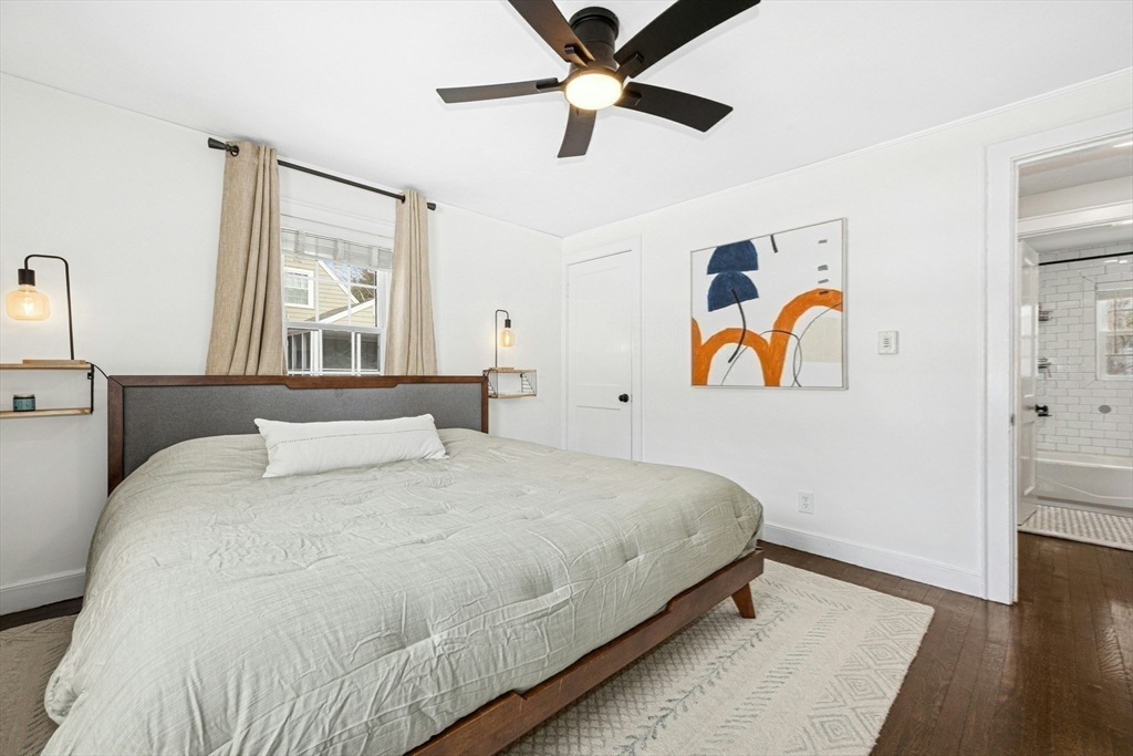 102 Spruce Street Framingham, MA 01701 - Photo 21 of 30 a bedroom with a bed and wooden floor